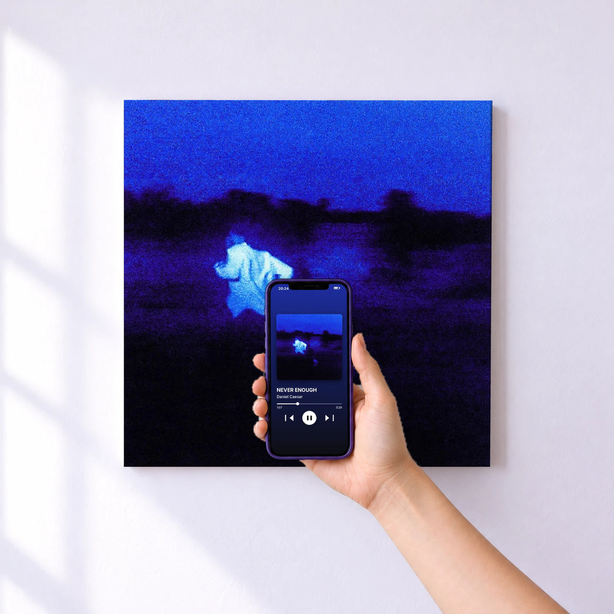 Affiche connectée NEVER ENOUGH de Daniel Caesar au mur : l'album se lance en approchant le téléphone