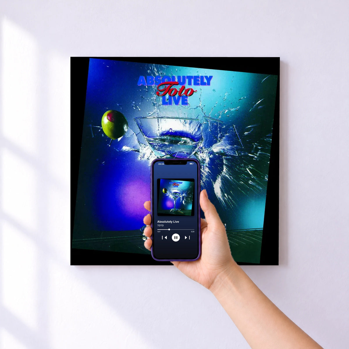 Affiche connectée Absolutely Live de TOTO au mur : l'album se lance en approchant le téléphone
