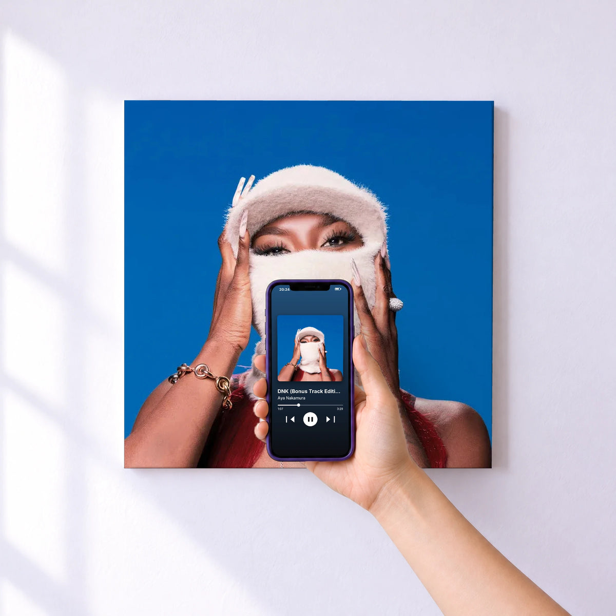 Affiche connectée DNK (Bonus Track Edition) de Aya Nakamura au mur : l'album se lance en approchant le téléphone