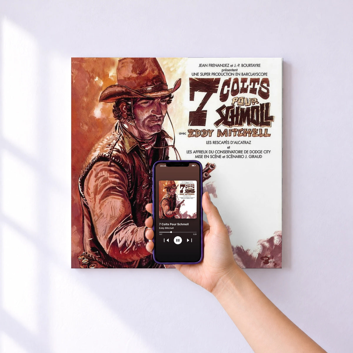 Affiche connectée 7 Colts Pour Schmoll de Eddy Mitchell au mur : l'album se lance en approchant le téléphone