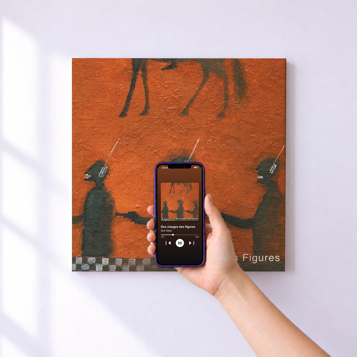 Affiche connectée Des visages des figures de Noir Désir au mur : l'album se lance en approchant le téléphone