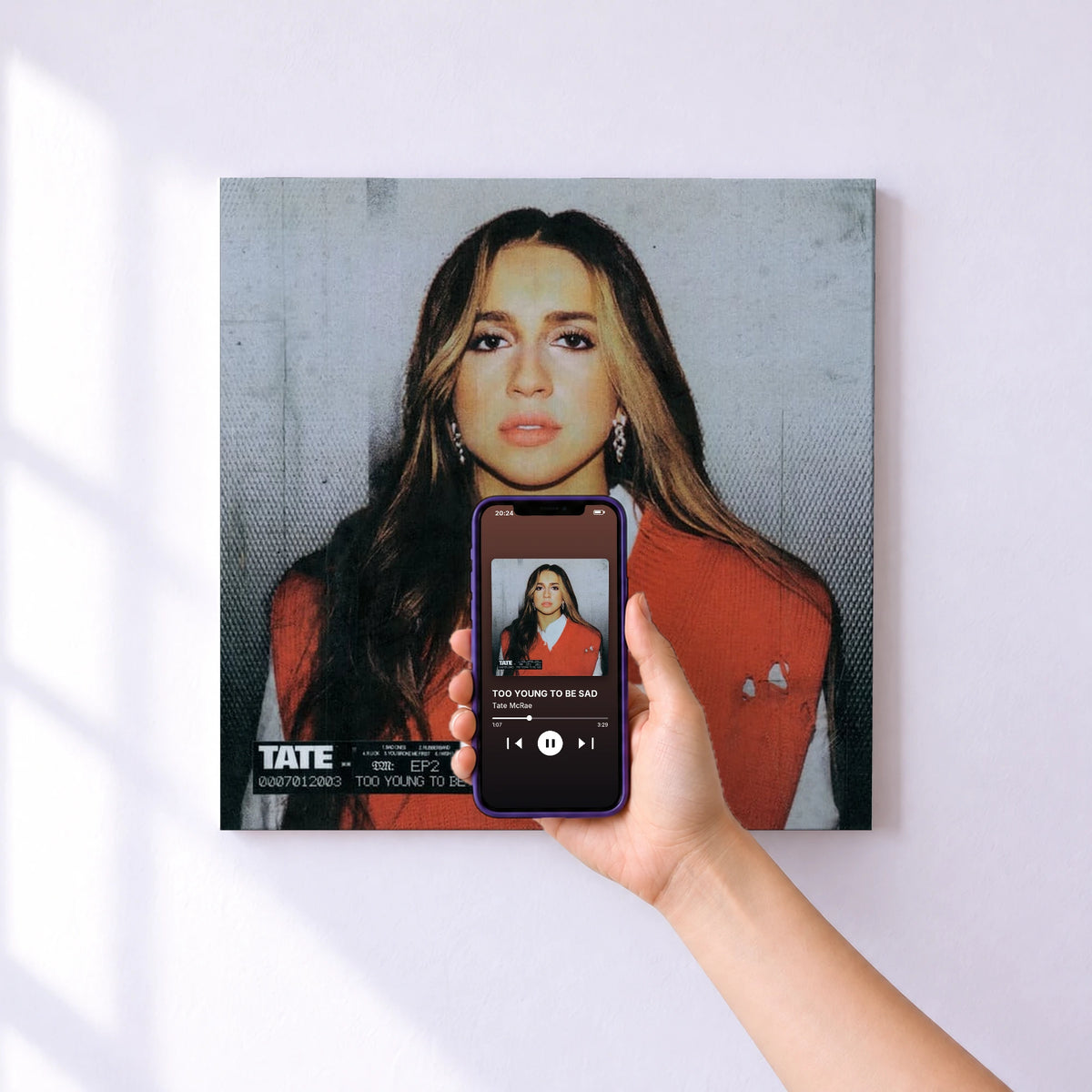 Affiche connectée TOO YOUNG TO BE SAD de Tate McRae au mur : l'album se lance en approchant le téléphone