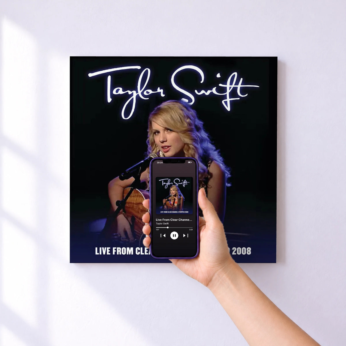 Affiche connectée Live From Clear Channel Stripped 2008 de Taylor Swift au mur : l'album se lance en approchant le téléphone