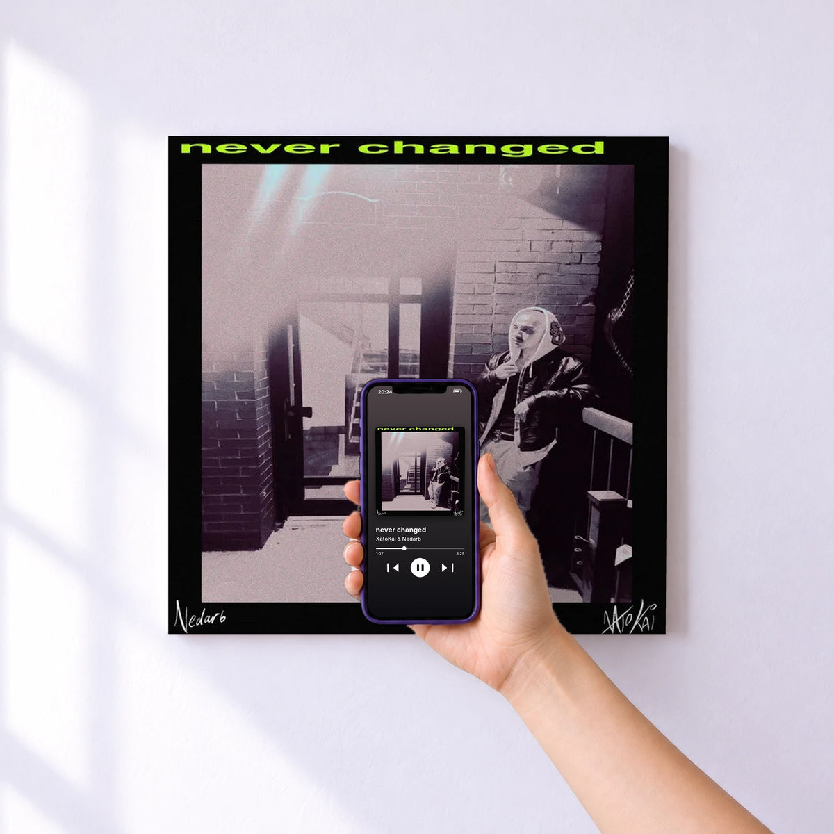 Affiche connectée never changed de XatoKai & Nedarb au mur : l'album se lance en approchant le téléphone